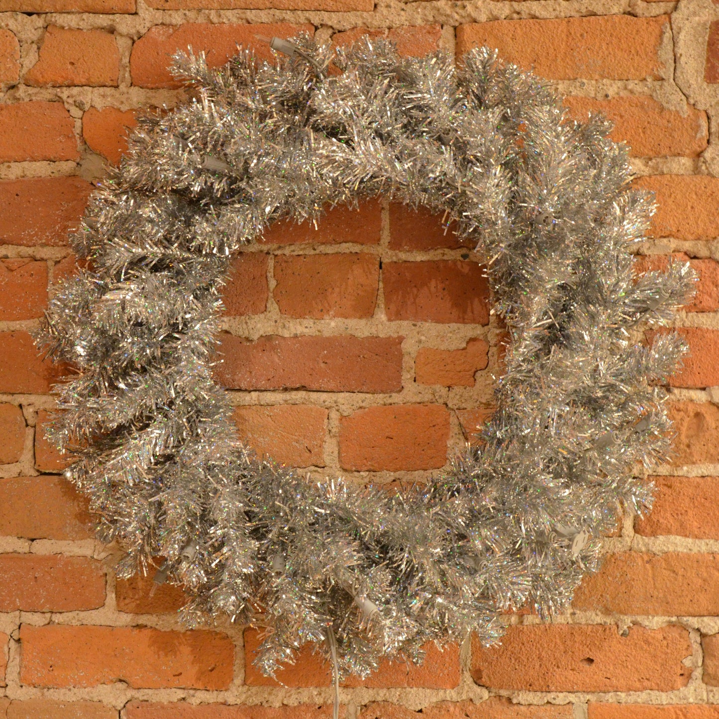 24“ Silver Artificial Christmas Wreath with 180 PVC Tips and 50 Warm White Dura-Lit Italian LED Mini Lights. Incorporate bright and modern holiday décor into your space with this beautiful wreath